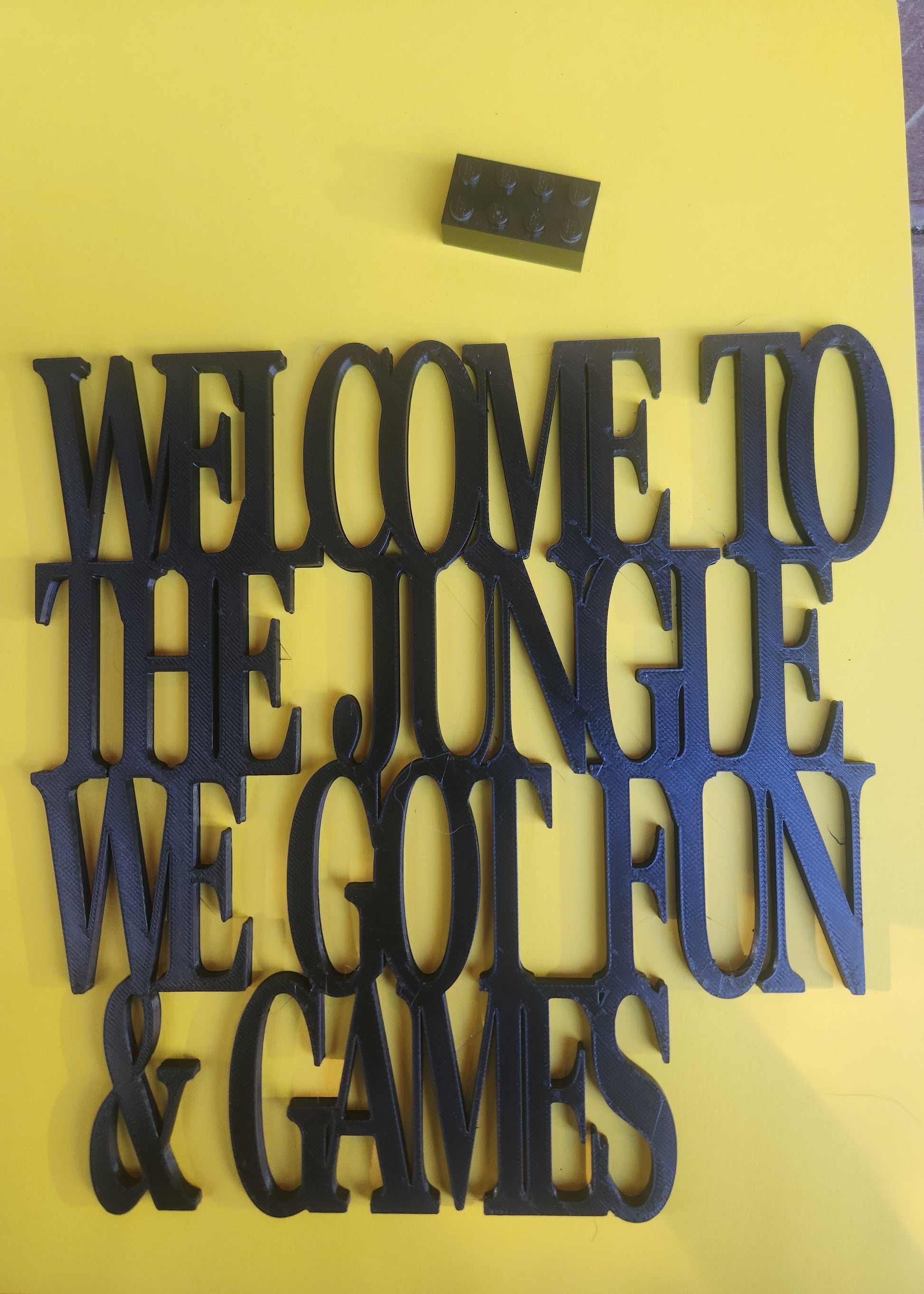 Welcome to the Jungle 3D printed sign with ego brick for scale reference