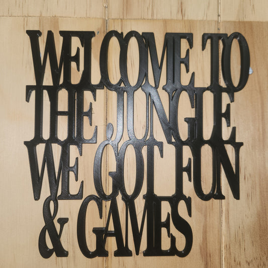 Welcome to the Jungle 3D printed black wall art sign mounted on wooden wall in games room setting