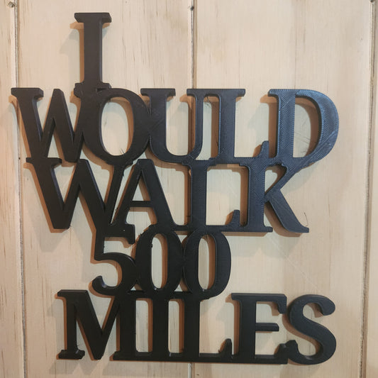 I Would Walk 500 Miles 3D printed sign in black on whitewashed wooden wall