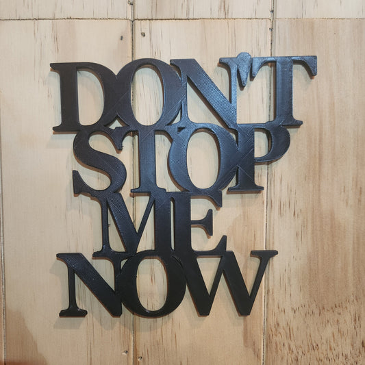 Black PLA 3D printed 'Don't Stop Me Now' wall art sign hanging on whitewashed wooden wall