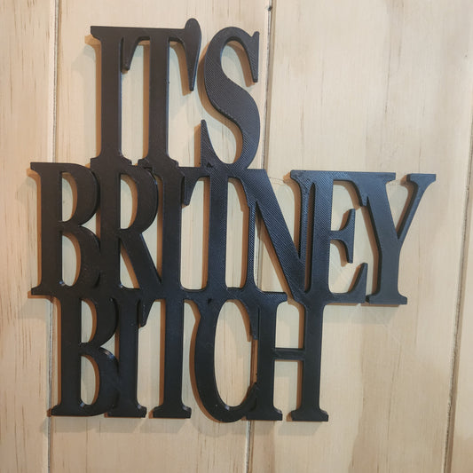 It's Britney B*tch 3D printed wall sign in black, mounted on wooden wall with blu-tack