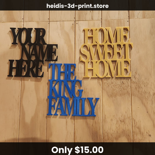 Three example custom signs — "YOUR NAME HERE", "THE KING FAMILY", and "HOME SWEET HOME" — arranged on the whitewashed wood wall in different colours