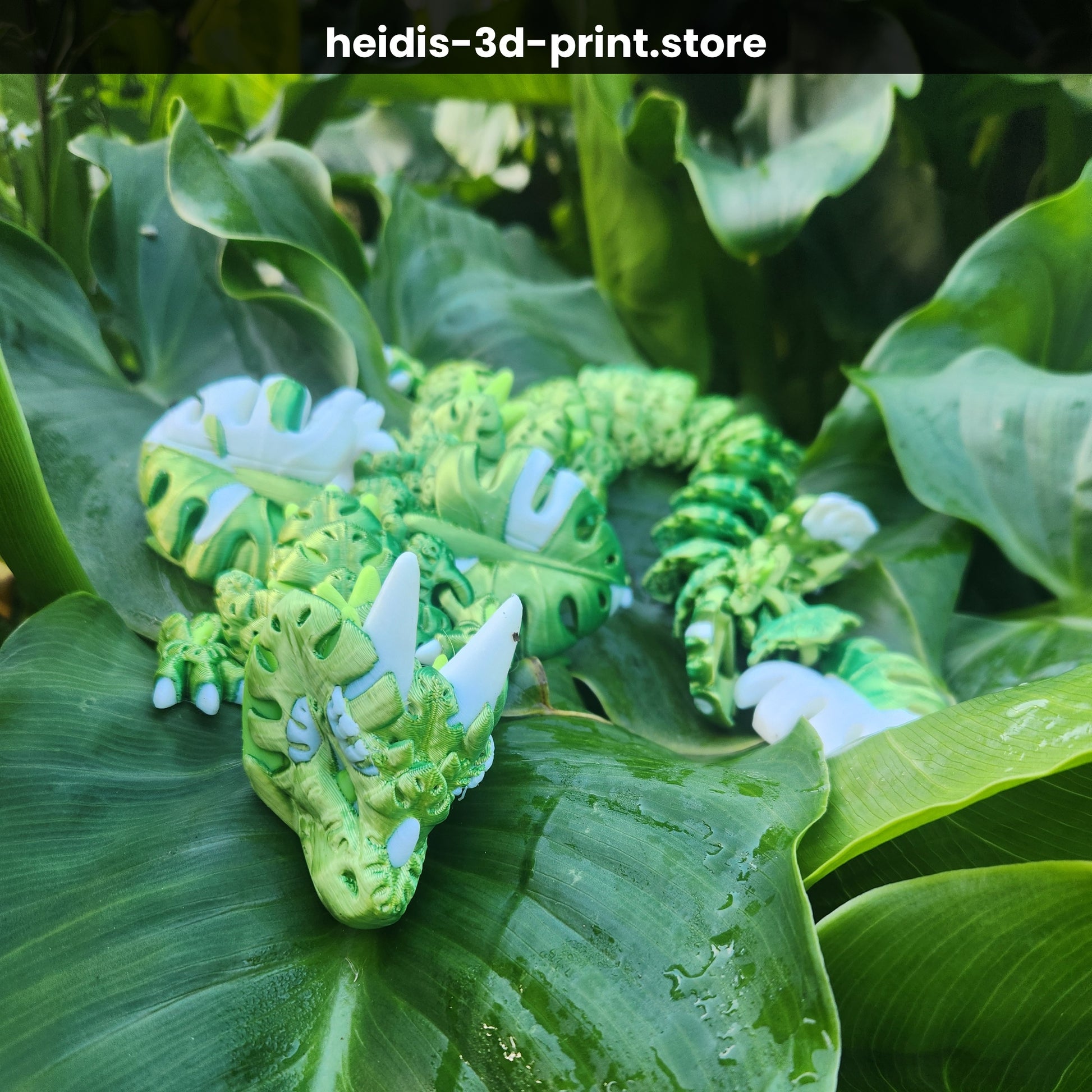 3D printed Monstera Leaf Dragon figure in deep green and white, fully articulated, head close-up showing intricate monstera leaf body texture and white horns, handmade in Upper Hutt NZ by Heidi's 3D Prints